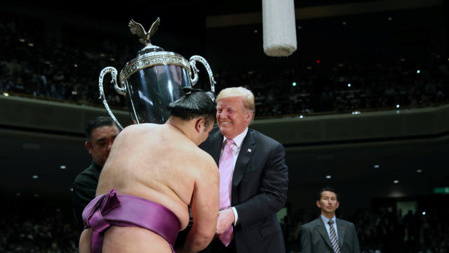 U.S. President Donald Trump presents the President’s Cup to wrestler Asanoyama, the winner of the Summer Grand Sumo Tournament at Ryogoku Kokigikan Sumo Hall in Tokyo 