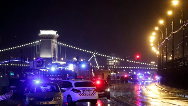 Police and fire brigade vehicles are seen on the Danube bank after tourist boat capsized on the river&nbsp;in Budapest 