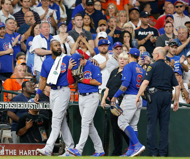 Chicago Cubs' Albert Almora Jr., right, reacts after hitting a foul ball  into the stands as, from left to right, Jason Heyward, manager Joe Maddon  and Javier Baez talk with him during