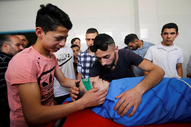 Relatives of Palestinian teenager Abdullah Ghaith look at his body at a hospital in Hebron, in the Israeli-occupied West Bank 