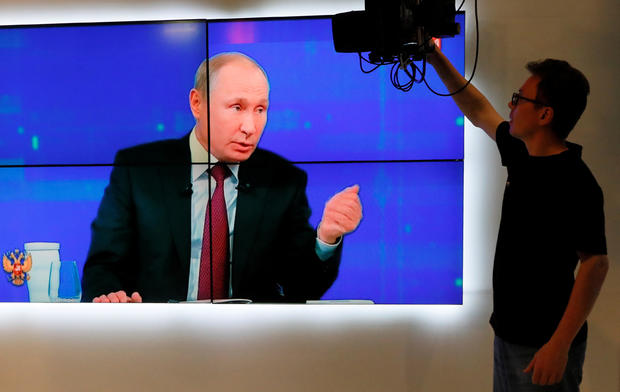 An employee works at a studio of a regional TV company during a televised phone-in show attended by Russian President Putin in Krasnoyarsk 
