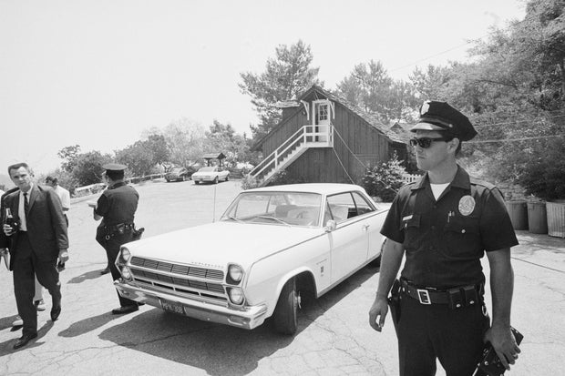 Police Officers Waiting Near a Car