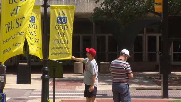 In No God We Trust banners in downtown Fort Worth