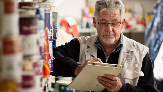 Senior Man Taking Inventory 