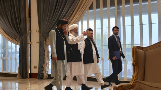 Members of Afghan delegations walk during the second day of  Intra-Afghan conference for peace in Doha 