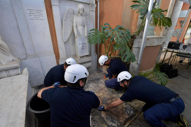 People open tombs in a cemetery on the Vatican's grounds 