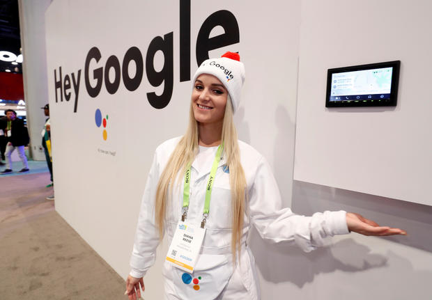 Demonstrator Diana Reese poses by an auto infotainment system equipped with Google Assistant in the JVC-Kenwood booth during the 2019 CES in Las Vegas 