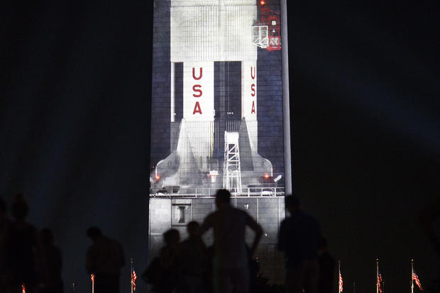 Image Of Saturn V Rocket Projected Onto Washington Monument In Honor Of Apollo 11 