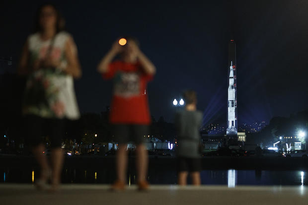 Image Of Saturn V Rocket Projected Onto Washington Monument In Honor Of Apollo 11 
