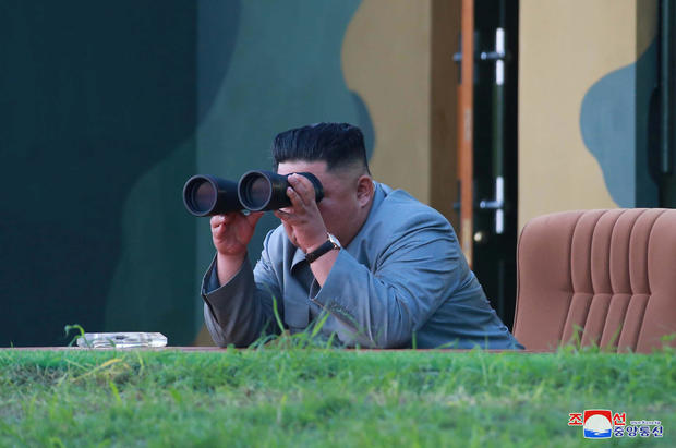 North Korean leader Kim Jong Un watches the test-fire of two short-range ballistic missiles 