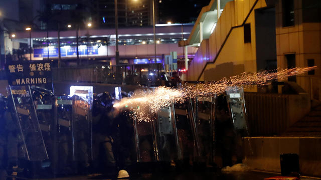 Riot police fire tear gas at demonstrators during a protest against police violence in Hong Kong 