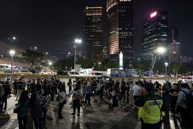 People gather outside an office building following an earthquake hit in Jakarta 