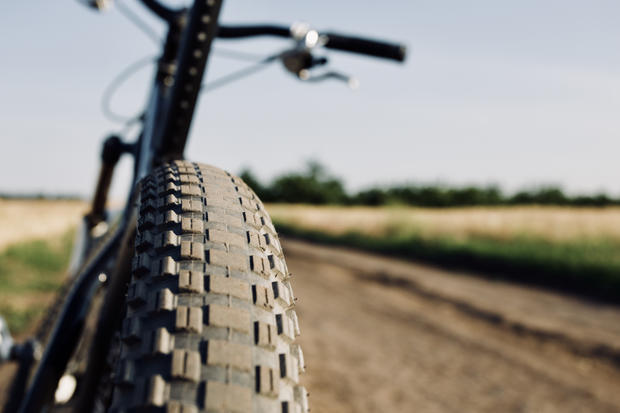Mountain bike wheel close-up on blurred nature background 