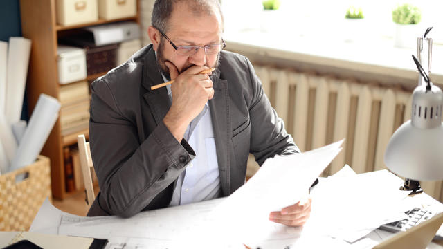 Mature Adult man working in the office 