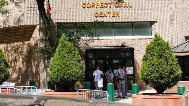Security personnel and people are seen at the entrance of the Metropolitan Correctional Center jail where financier Jeffrey Epstein was held in the Manhattan borough of New York City Aug. 12, 2019. 