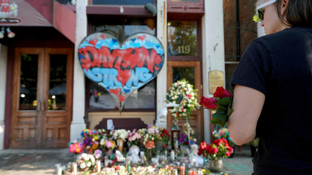 FILE PHOTO: A Oregon District resident stands at a memorial for those killed during Sunday morning's a mass shooting in Dayton 