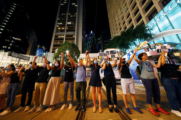 Protesters hold hands to form a human chain during a rally to call for political reforms in Hong Kong's Central district 