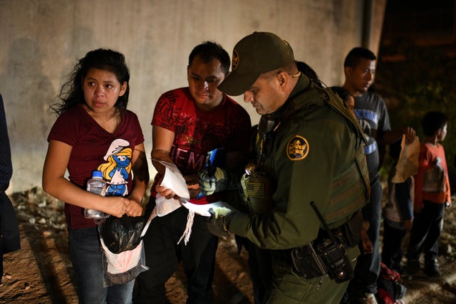 Migrant families turn themselves in to U.S. Border Patrol to seek asylum following an illegal crossing of the Rio Grande in Hidalgo