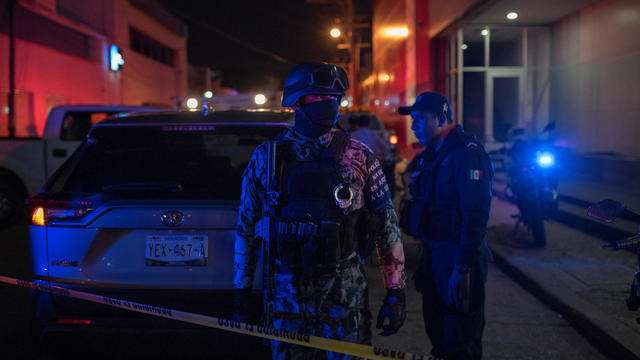 Federal forces keep watch at a crime scene following a deadly attack at a bar by unknown assailants in Coatzacoalcos 