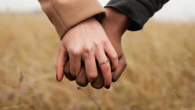 Engaged couple holding hands 