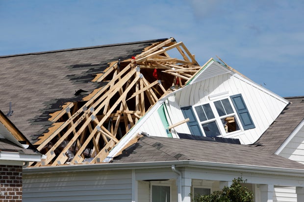 The roof of a home is ripped open by a tornado spawned by Hurricane Dorian in Carolina Shores, North Carolina