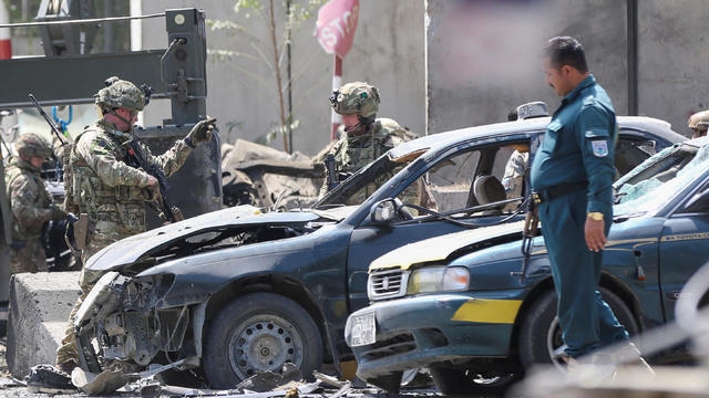 Foreign troops with NATO-led Resolute Support Mission investigate at the site of a suicide attack in Kabul 