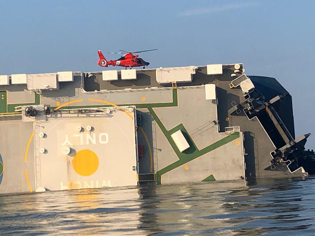 ​A U.S. Coast Guard helicopter hovers over an overturned cargo ship in Georgia's St. Simons Sound September 9, 2019, in an image released by the Coast Guard. 