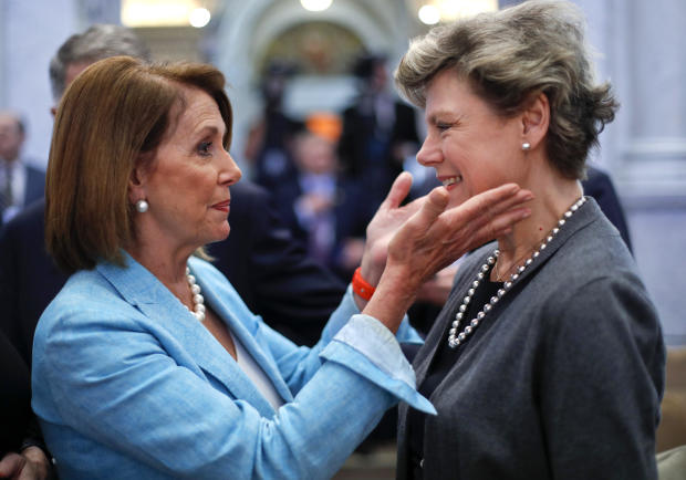 Then-House Democratic Leader Nancy Pelosi, left, greets journalist Cokie Roberts in the Great Hall of the Library of Congress in Washington, September 14, 2016. Both women attended the oath of office ceremony for the new librarian of Congress, Carla Hayden. 