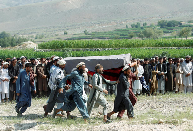 Men carry a coffin of one of the victims after a drone strike, in Khogyani district of Nangarhar province, Afghanistan 