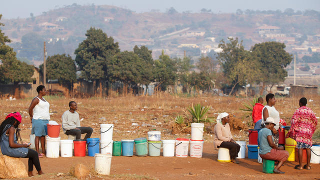 Locals wait for their turn to collect water from a borehole in Warren Park, Harare 
