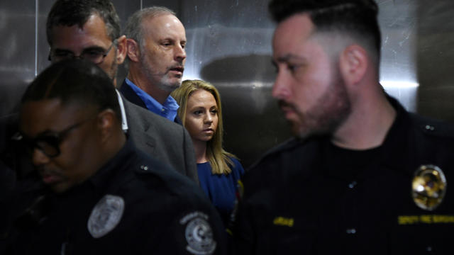 Amber Guyger, who is charged in the killing of Botham Jean in his own home, arrives on the first day of the trial in Dallas 