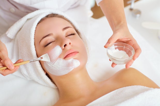 Woman in mask on face in spa beauty salon 