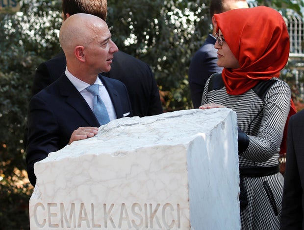 Hatice Cengiz, fiancee of murdered Saudi journalist Jamal Khashoggi, and Jeff Bezos, founder of Amazon and Blue Origin, talk as they attend a ceremony marking the first anniversary of Khashoggi's killing at the Saudi Consulate in Istanbul, Turkey, October 2, 2019.
