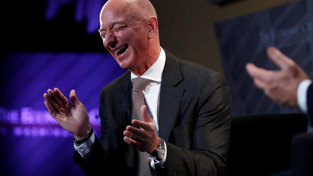 Jeff Bezos, president and CEO of Amazon and owner of The Washington Post, laughs during an interview at the Economic Club of Washington DC's "Milestone Celebration Dinner" in Washington 