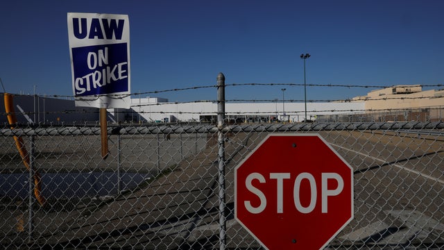 A union strike sign is stuck in the fence outside the GM Flint Truck Assembly in Flint 