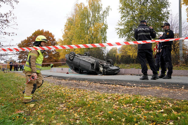 An overturn car is seen on the road, after it was allegedly struck by an ambulance which was stolen by an armed man in Oslo 