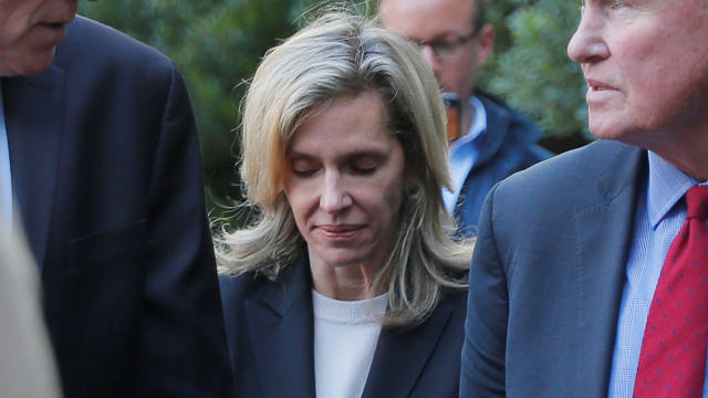 Jane Buckingham walks in to the federal courthouse for her sentencing hearing in Boston 