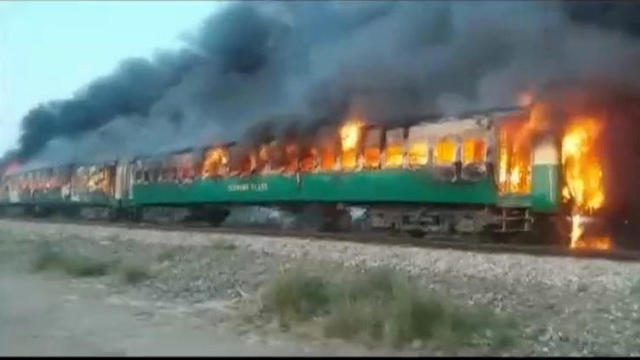 Video grab of a fire burning in a train carriage after a gas canister passengers were using to cook breakfast exploded, near the town of Rahim Yar Khan 