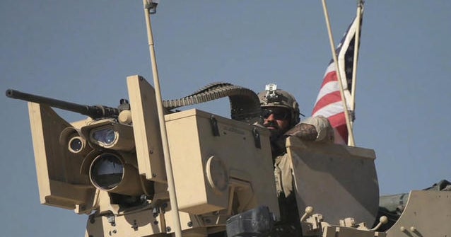 On the ground with U.S. military convoy protecting oil fields in northern Syria