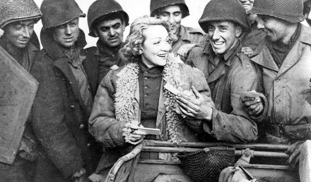Marlene Dietrich with American soldiers, 1943. Image shot 1943. Exact date unknown. 