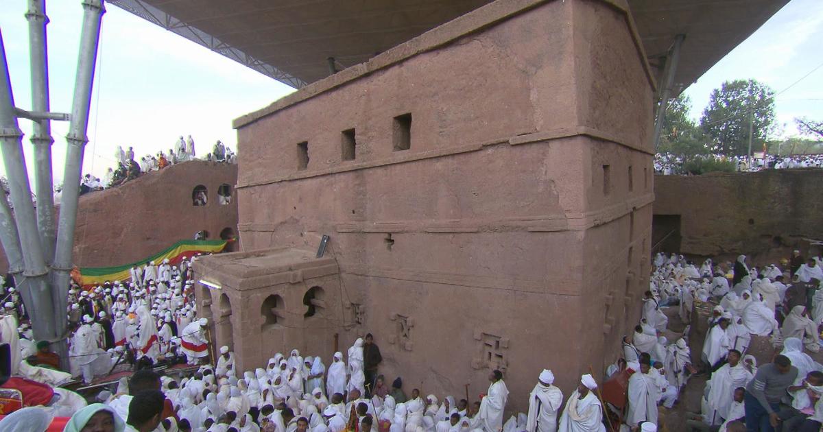 Priest in Bet Danaghel Church holding the Cross of King Lalibela. The  rock-hewn churches of Lalibela make it one of the greatest  Religio-Historical sites not only in Africa but in the Christian