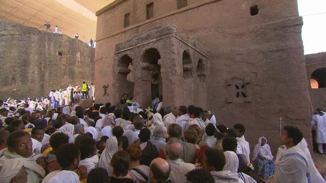 Priest in Bet Danaghel Church holding the Cross of King Lalibela. The  rock-hewn churches of Lalibela make it one of the greatest  Religio-Historical sites not only in Africa but in the Christian