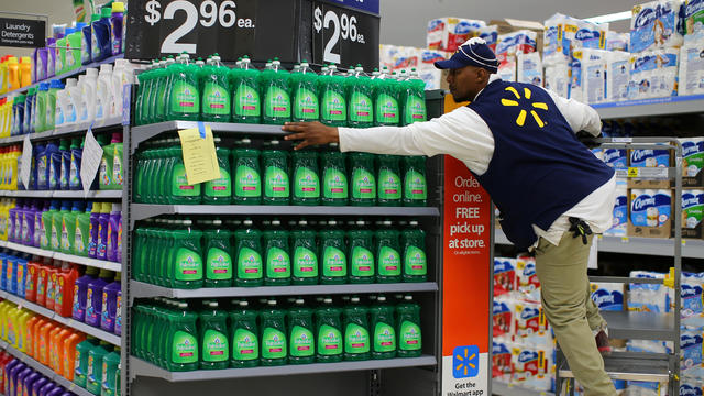 A worker sets up a display of dish washing liquid in prepare for the opening of a Walmart Super Center in Compton, California 