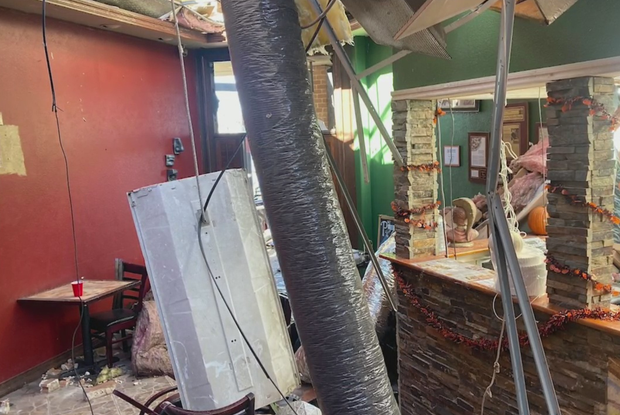 Tornado damage in Dallas restaurant in shopping center 