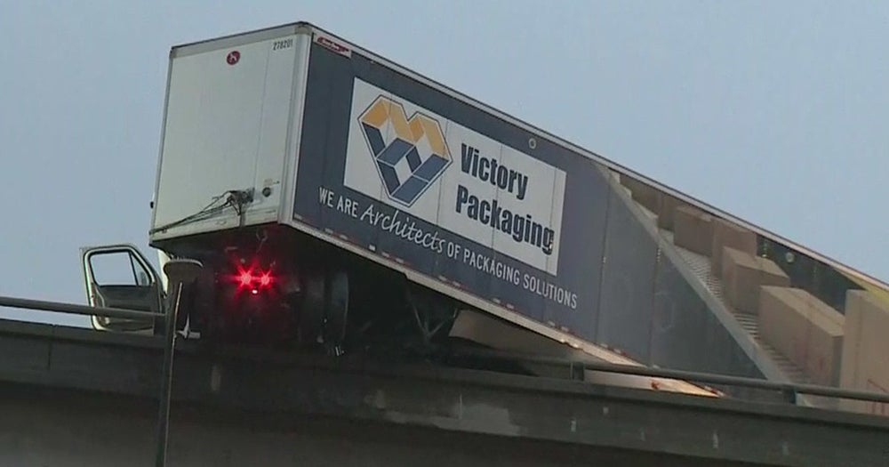 Big Rig Jackknifes, Dangles Over Side Of Freeway Transition Road In
