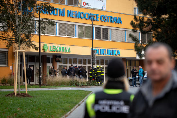 Police officers stand guard near the site of a shooting in Ostrava 