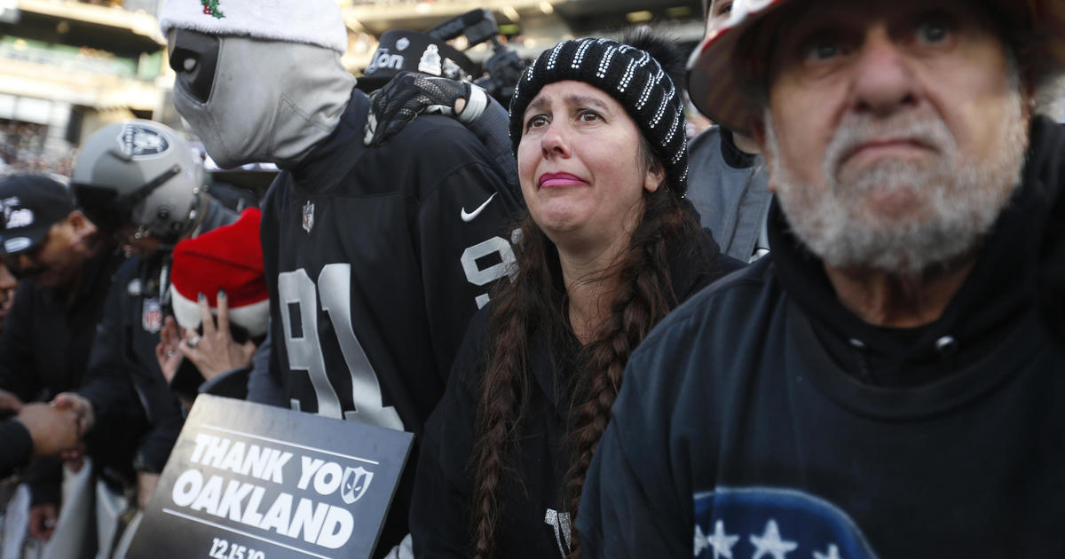 Oakland Raiders fans tailgate in rain at their team's likely last