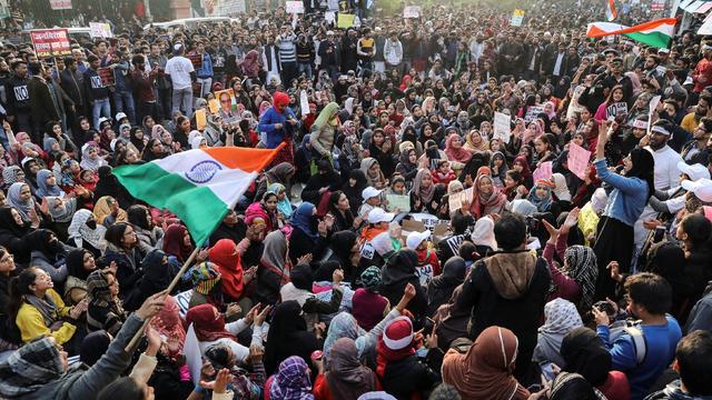 Demonstrators attend a protest against a new citizenship law, outside the Jamia Millia Islamia University in New Delhi 