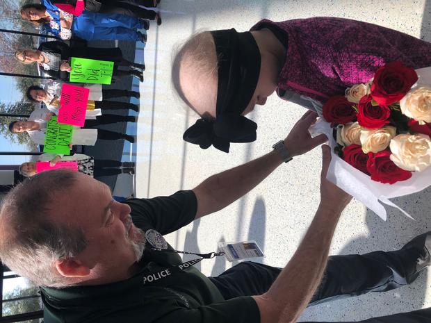 Lake Dallas Police officer gives flowers to Danielle Gonzalez 