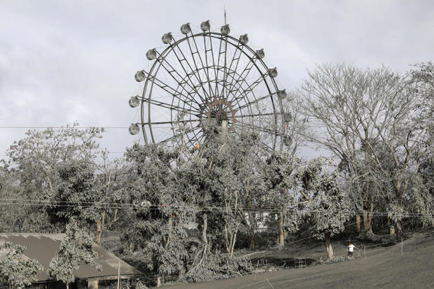 A ferris wheel is covered with volcanic ash in a park in Tagaytay City 
